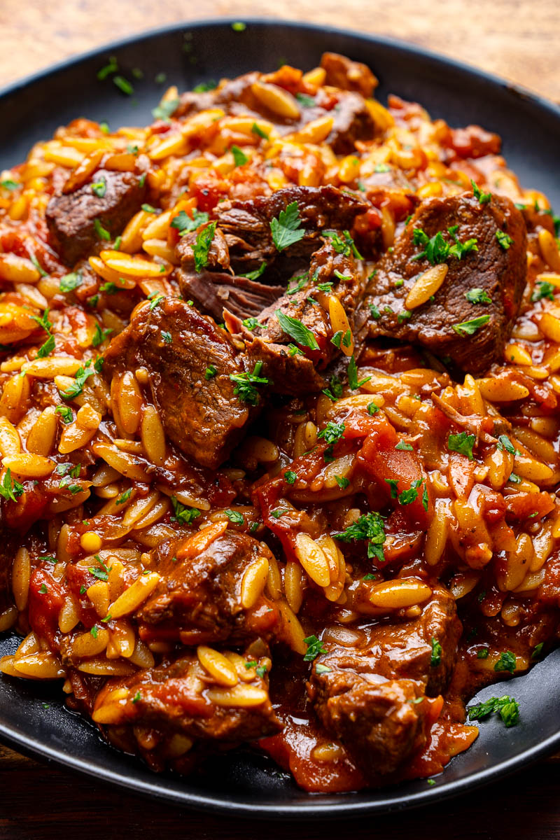 Greek-Style Beef & Orzo (GF) — Beef braised in a spiced tomato sauce with olive oil, tossed with orzo.